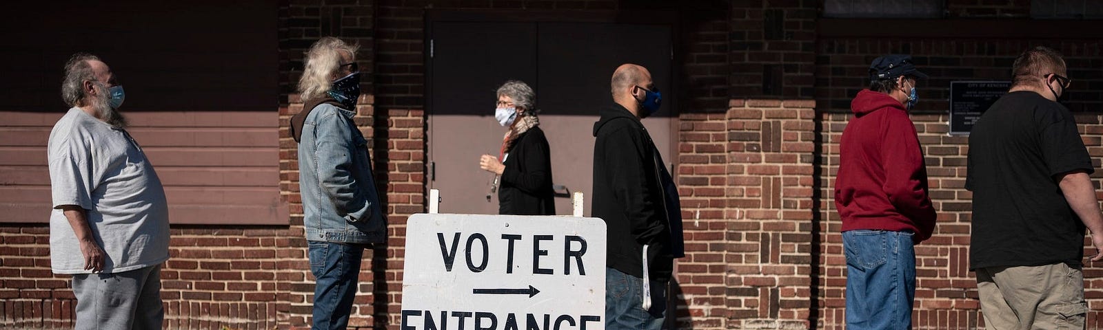 Voters wait in line outside a polling center on Election Day, Tuesday, Nov. 3, 2020, in Kenosha, Wis.