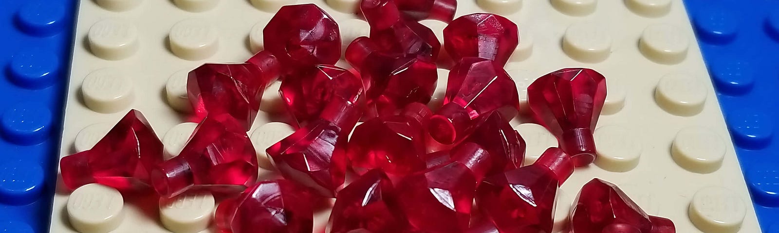 White and blue Lego pieces with some ruby pins