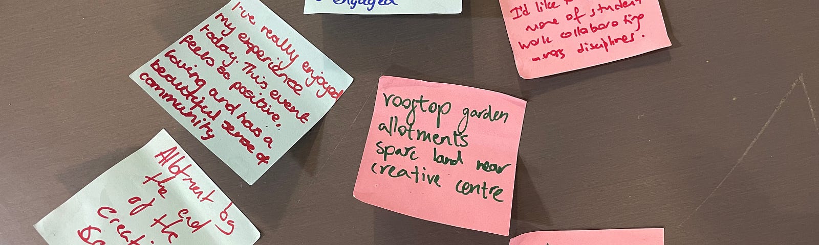 Post-it notes stuck to a table, displaying participants’ thoughts about a community gardening workshop at a project launch event