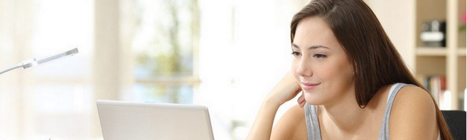 Photo of white female looking at computer