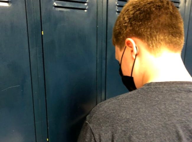 My son attempting to unlock his school locker.