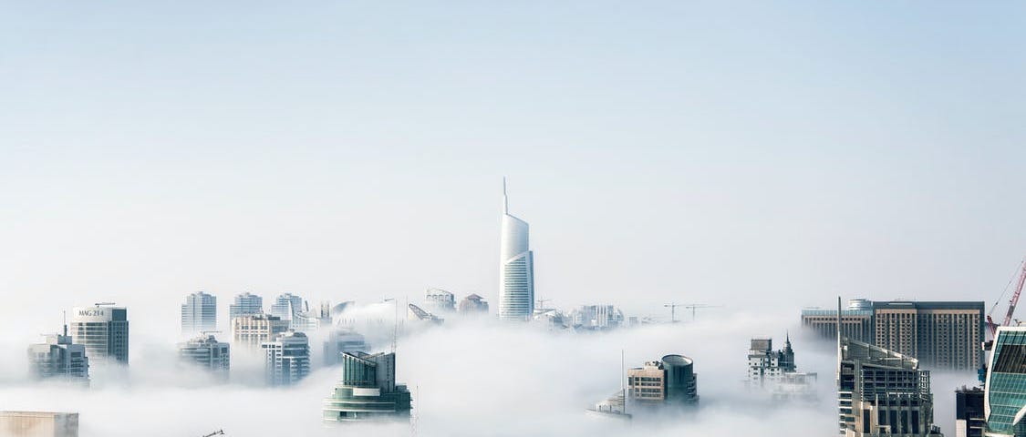 Floating city in the sky, surrounded by clouds.