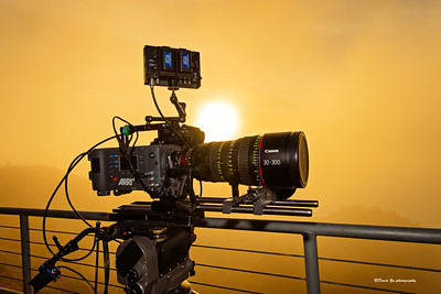 A video camera with a sunset in the background.