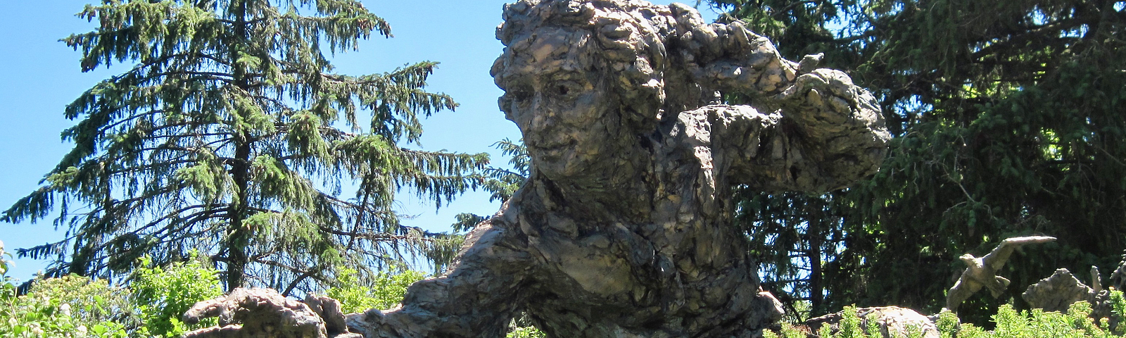 Photo of sculpture of man in nature, Chicago Botanical Gardens.