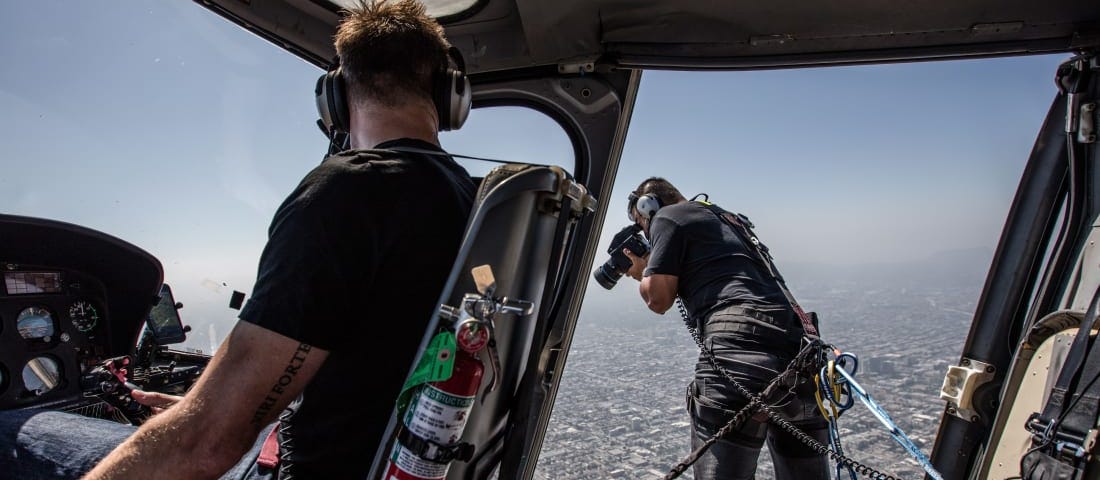 A photographer hung out of the helicopter using ropes, only to take some areal shots. Image credits: CNN