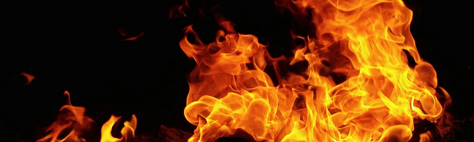 Photo of a raging fire, bright orange and yellow.