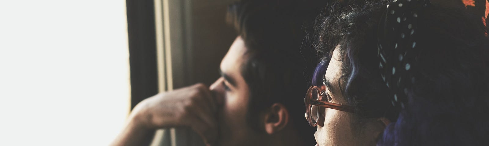 Two people looking out the window.