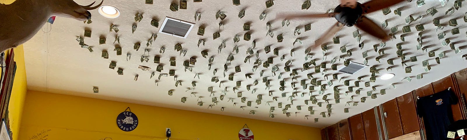 Cash taped to the ceiling of a restaurant