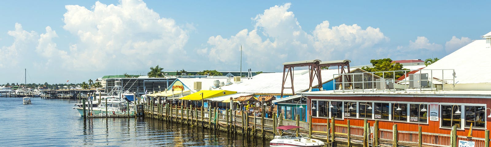 Boat moving down Naples Bay waterway