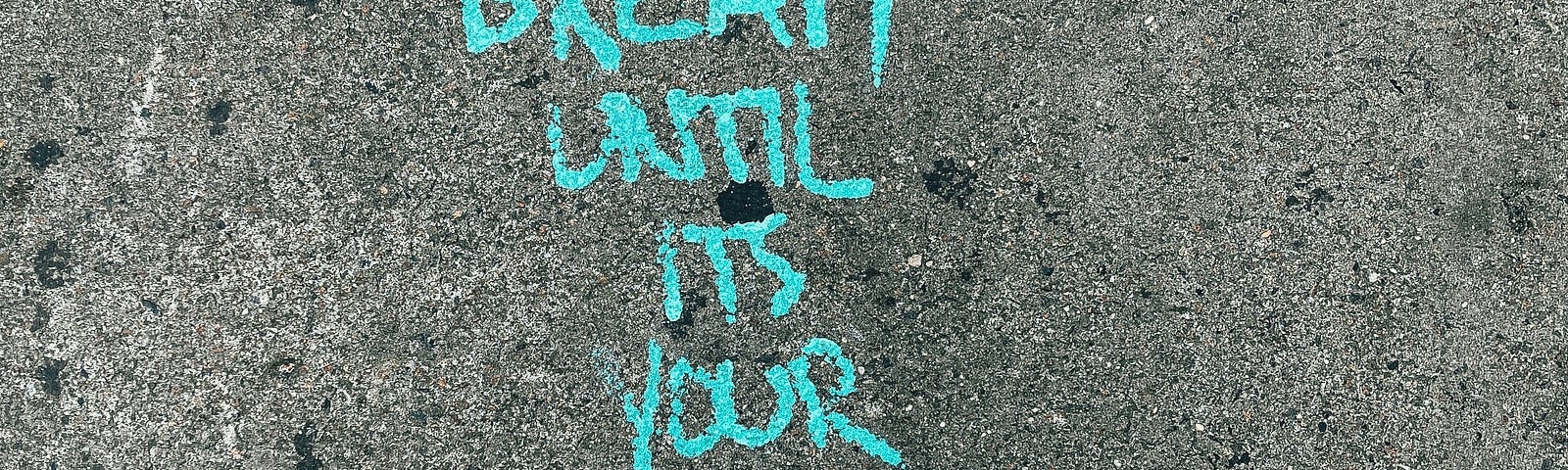 Dream until it is your reality written in chalk on a pavement