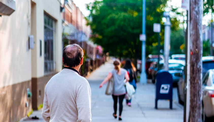 Man looks at a woman walking away