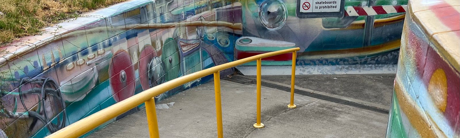 An underpass brightly painted with a pinball game