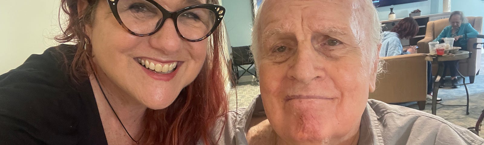 A photo of the author with her dad at his memory care center