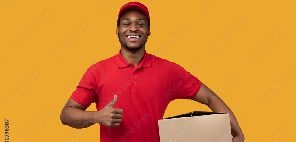 Smiling Black delivery man holding cardboard box