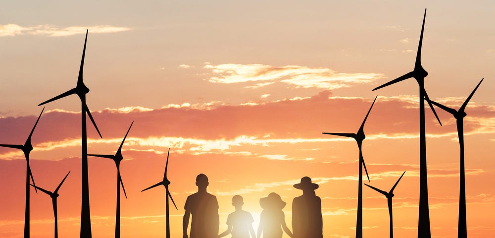 Picture of windmills and a family holding hands as silhouettes on a sunset background