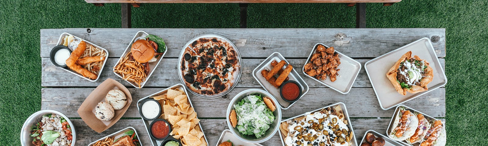 A rustic wooden table covered with food