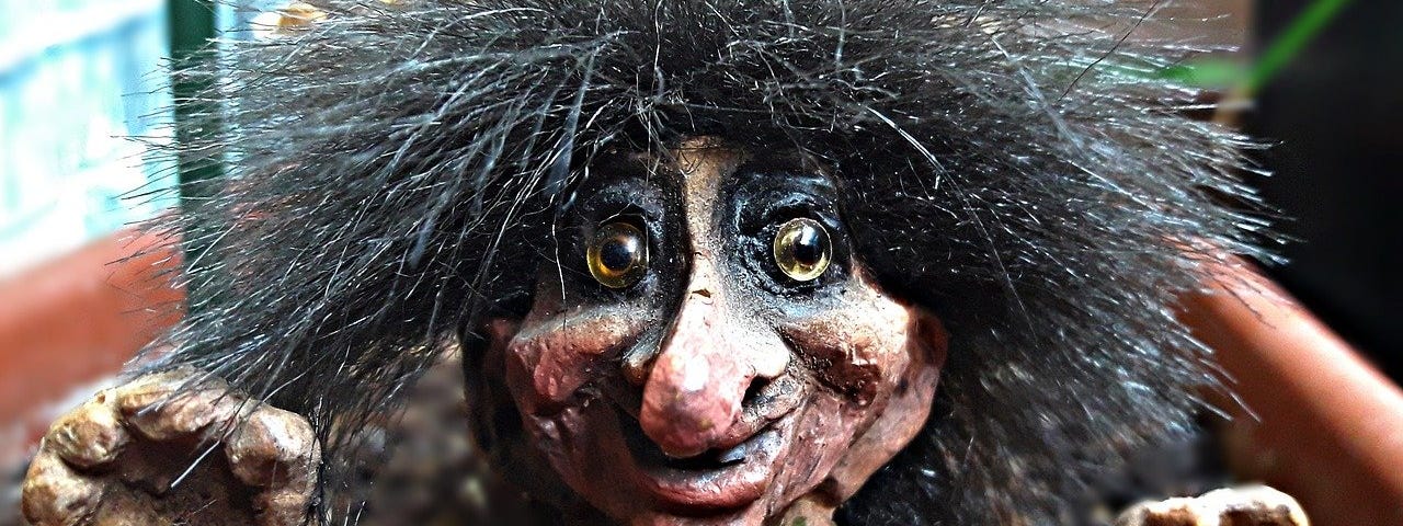 A troll sculpture with wiry hair sticking out all over.