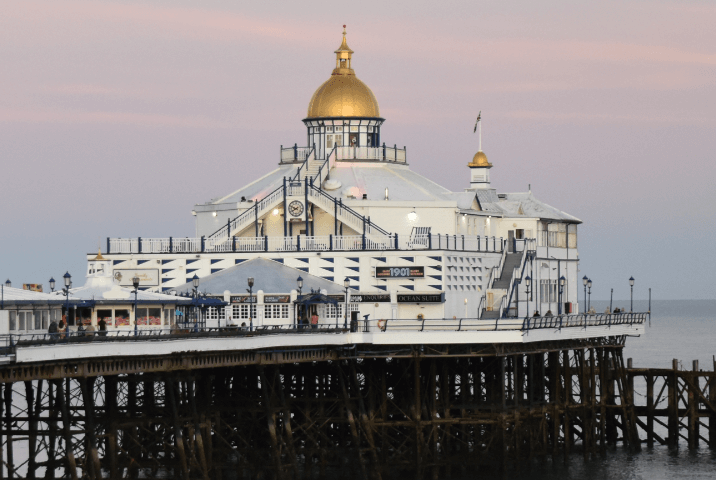 A seaside pier with a gold-domed white pavilion — Moral Letters to Lucilius