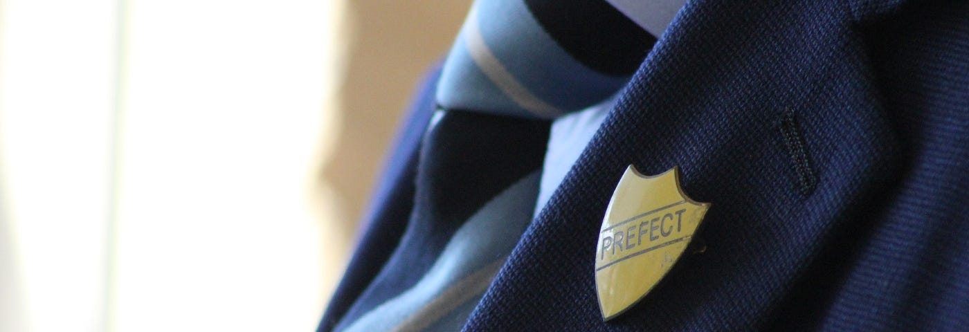 Prefect badge on a uniform