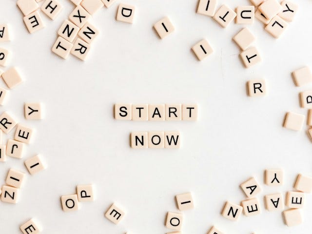 Scrabble tiles that in the middle say “Start Now”