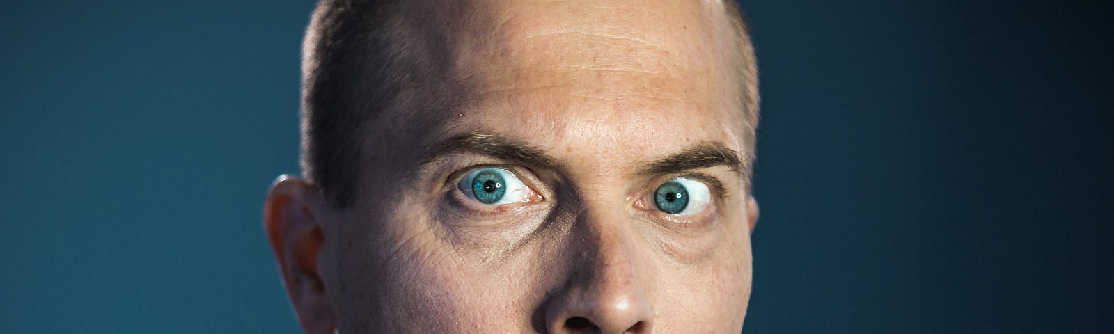Close view of a scared expression on a man’s face.