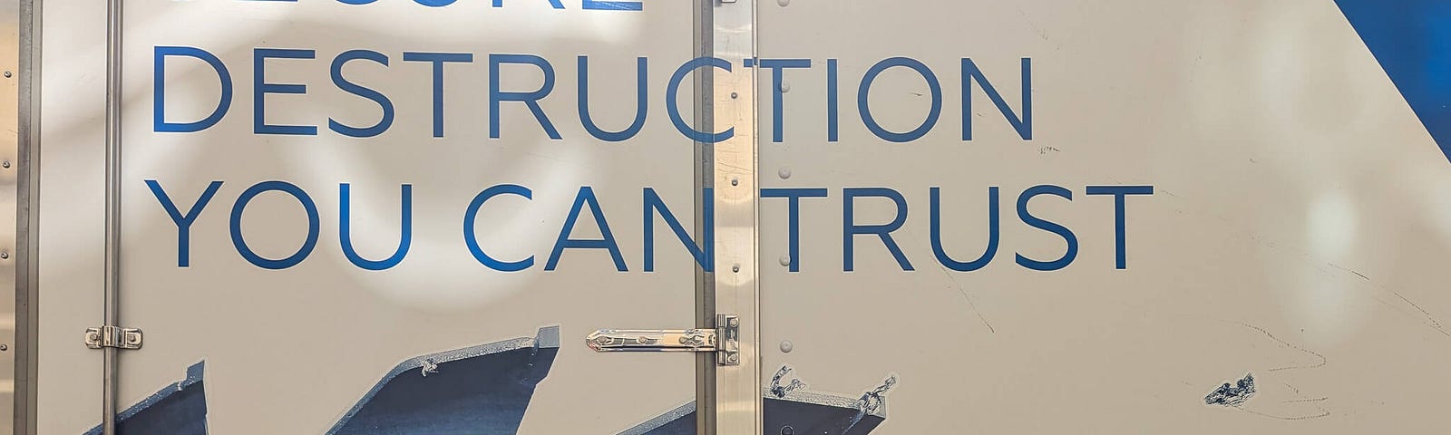 Truck panel reading “Secure Destruction You Can Trust” above a saw blade