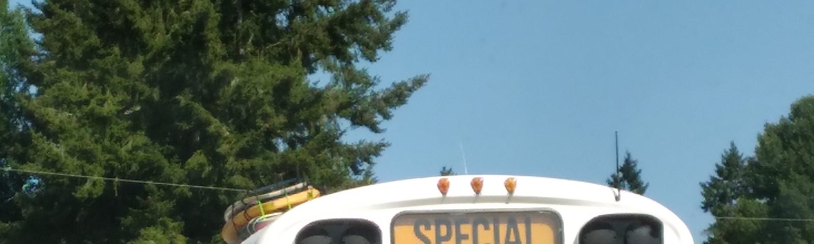 An old school bus that has the word special written above the from windshield