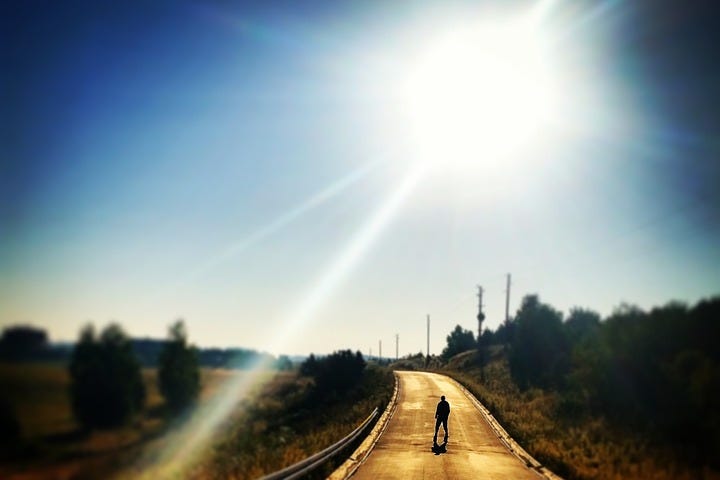 A lonely man walks along an empty street, a sunset head.