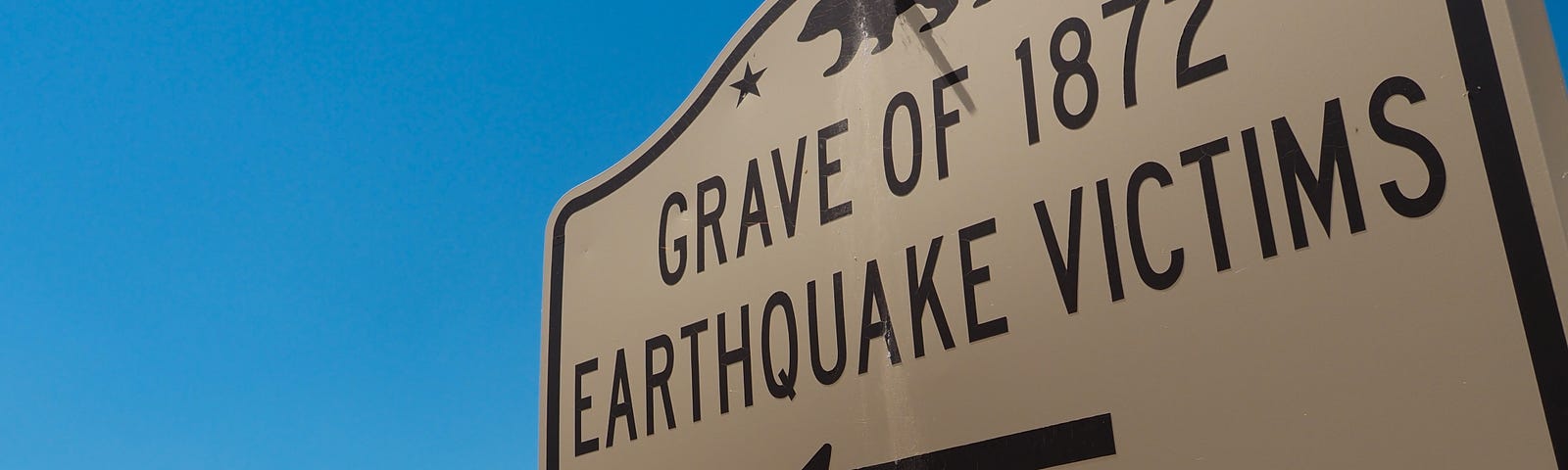 Historical marker at side of Highway 395 points way to memorial for victims of the massive 1872 Owens Valley Earthquake that leveled Lone Pine, CA, and killed 27 of 250 residents. The site includes a mass grave for 17 foreign-born residents who had no relatives to claim their bodies. The quake, which CalTech geologists now say may have been the largest in recorded history in the U.S. outside of Alaska, violently shook the whole of California and Nevada. (Photo: Craig K. Collins)