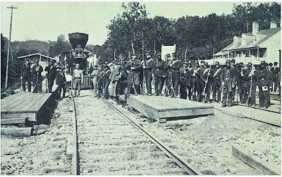 Union troops standing with a locomotive