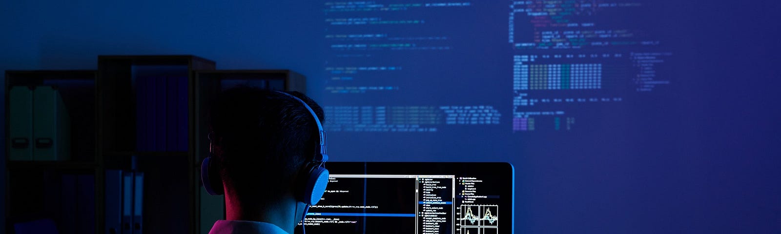 A programmer staring at a screen coding something
