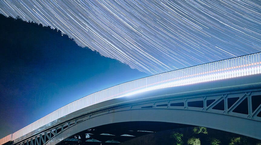 Bridge with long star trails behind