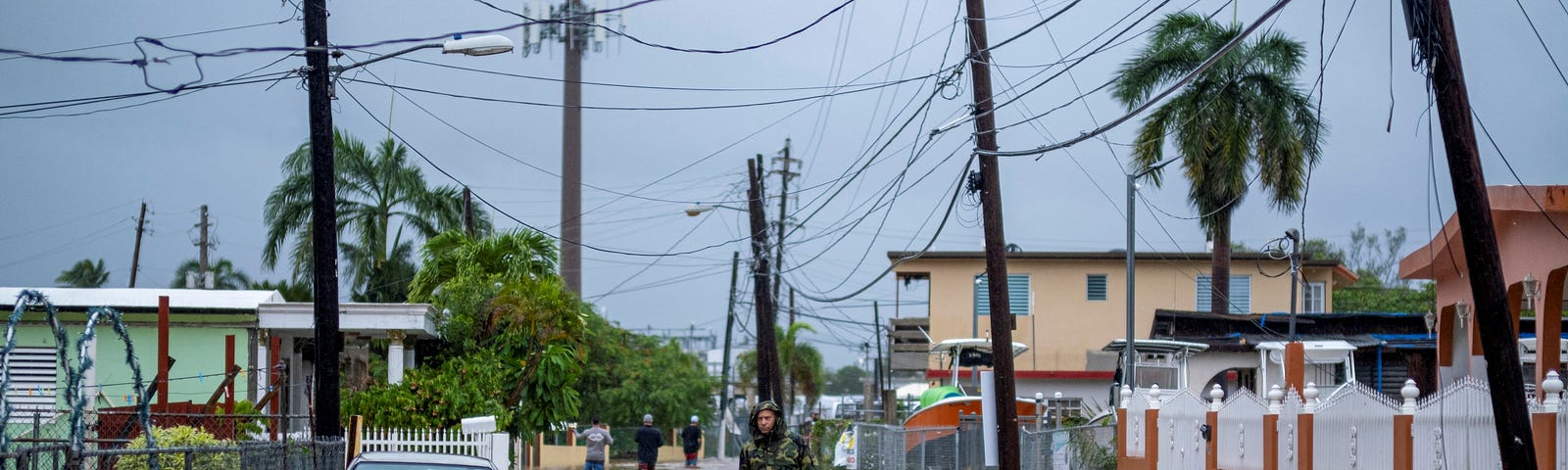 A member of the Puerto Rico National Guard wades through water in search for people to be rescued after Hurricane Fiona in Salinas, Puerto Rico, September 19, 2022. Photo by Ricardo Arduengo/Reuters