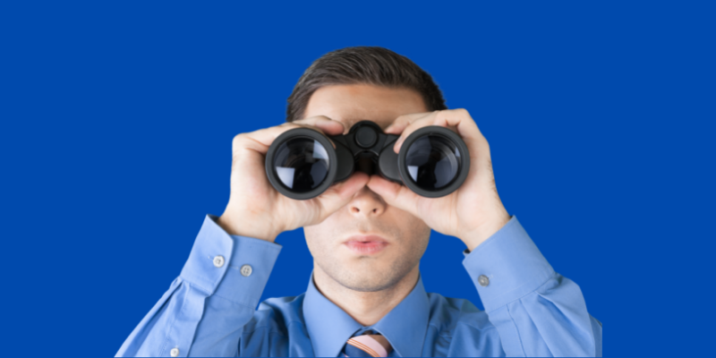 Man with binoculars — How I Make $5,000 Each Month Writing About Overlooked Topics