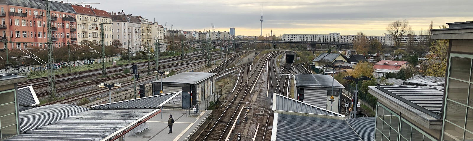 Berlin and the Fernsehturm in the background taken from a bridge above a train station
