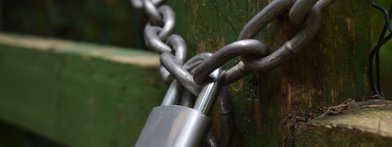 Padlock and chain securing a wooden structure