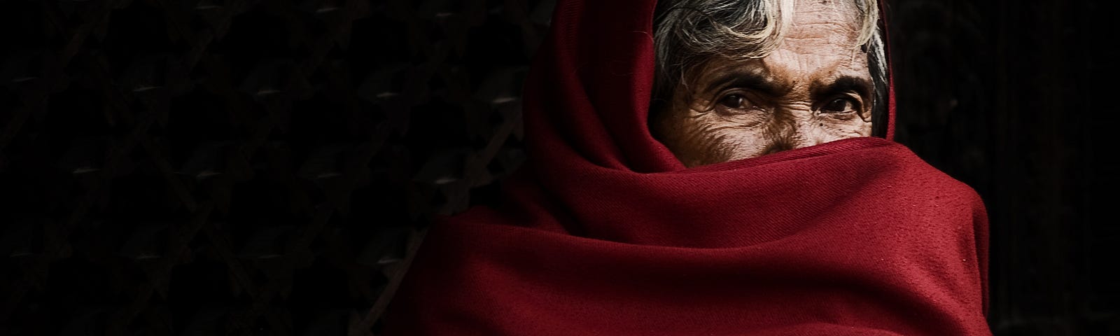 Old Tibetan woman half face covered, looking straight at the camera. The Tao — Why search for a new consciousness, when we are already conscious?