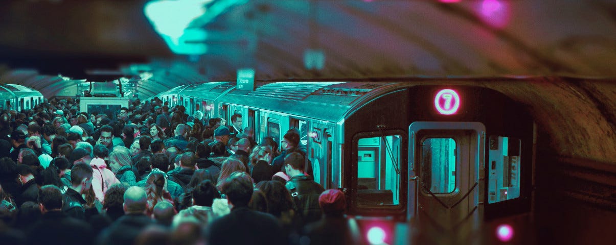 Commuters packed into the platform of a metro train.