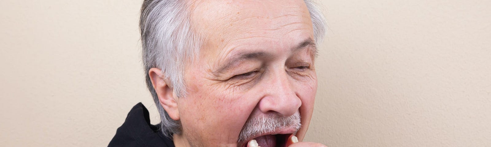 Man putting in his teeth