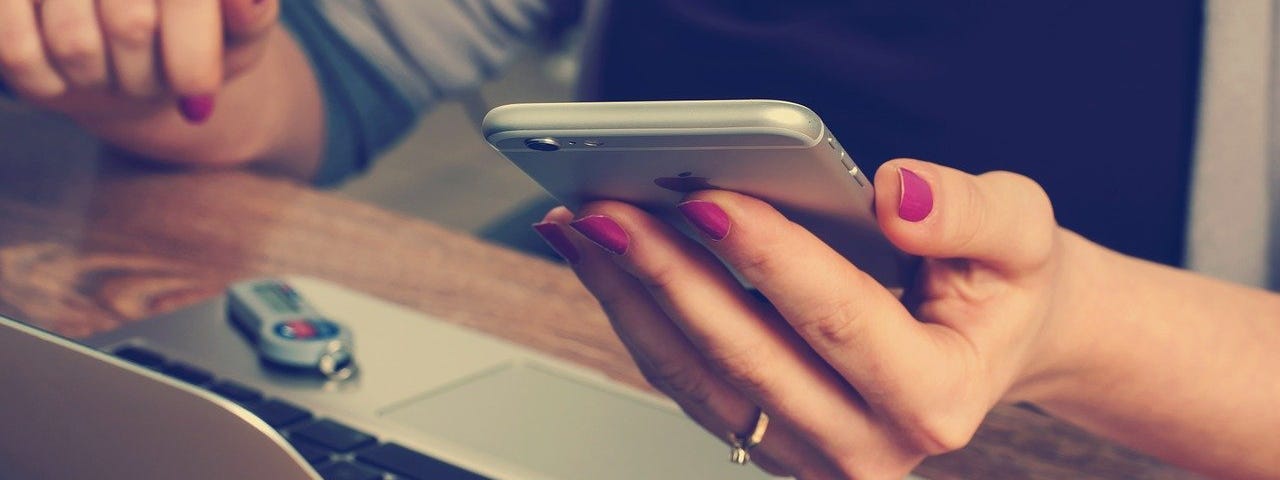 Woman glancing at a message on her mobile phone