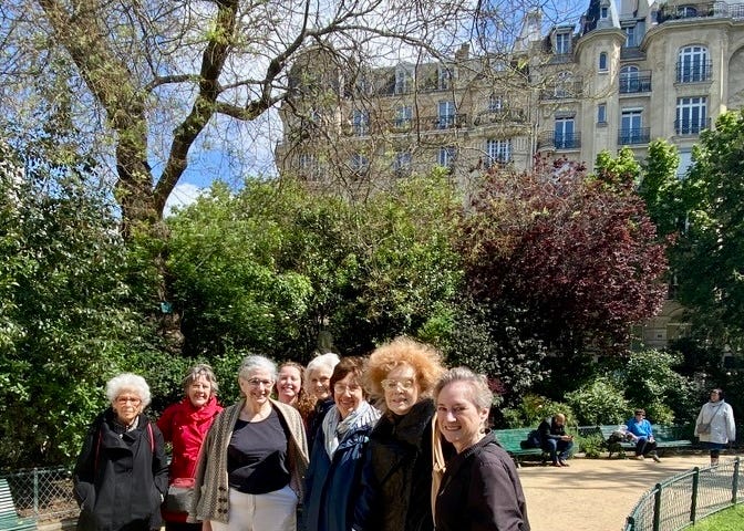 A group shot of friends pausing during a walk in Paris