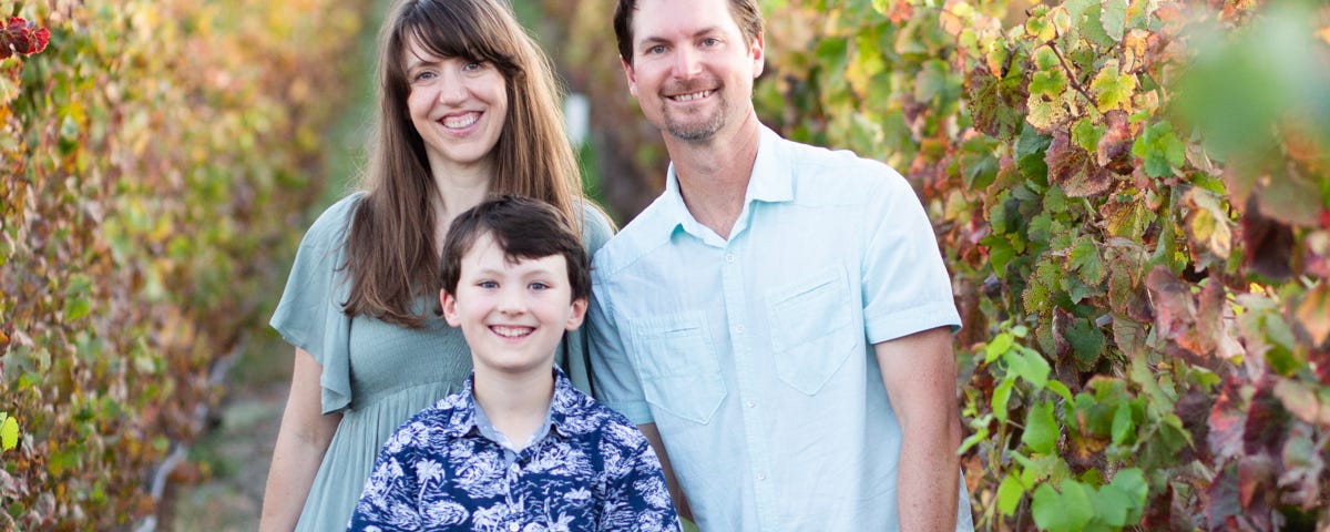 4 family members standing in vineyard