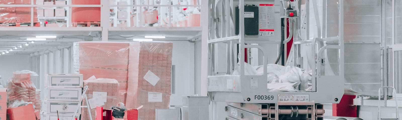 a white warehouse with orange boxes and a motorized cart