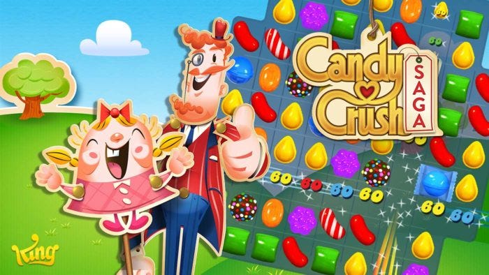 Two characters of Candy Crush Saga’s eccentric cast beam and give thumbs up beside the game’s title and token candy grid.