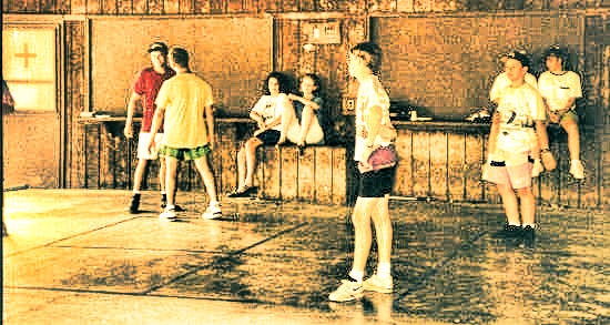 Kids playing four-square on a cement court