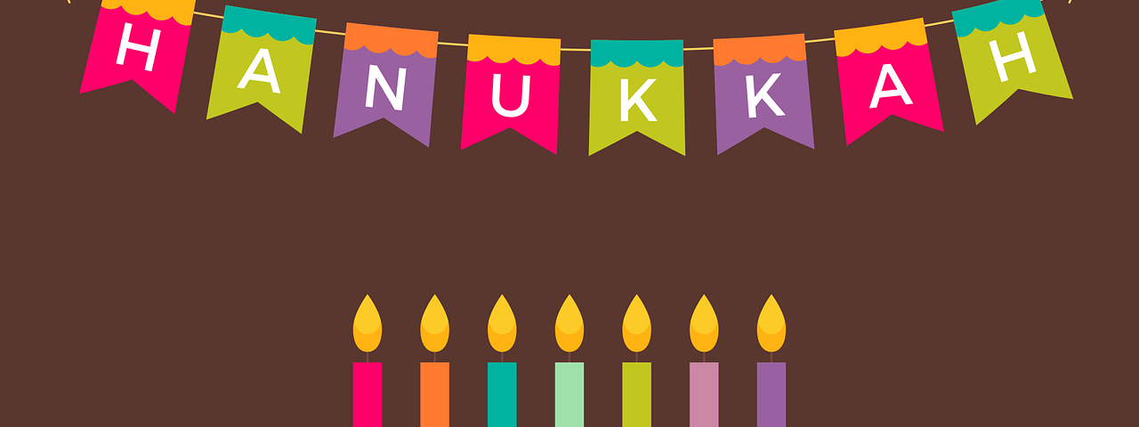 A graphic that says Happy Hanukkah with a menorah and other signs of the holiday.