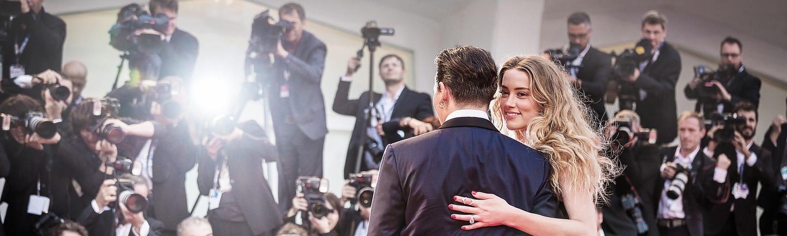 Amber Heard and Johnny Depp posing for cameras on the red carpet