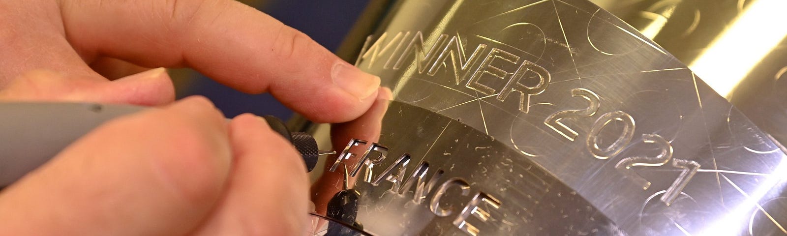 ZA picture of a UEFA official engraving France’ name on the nations league trophy for 2021