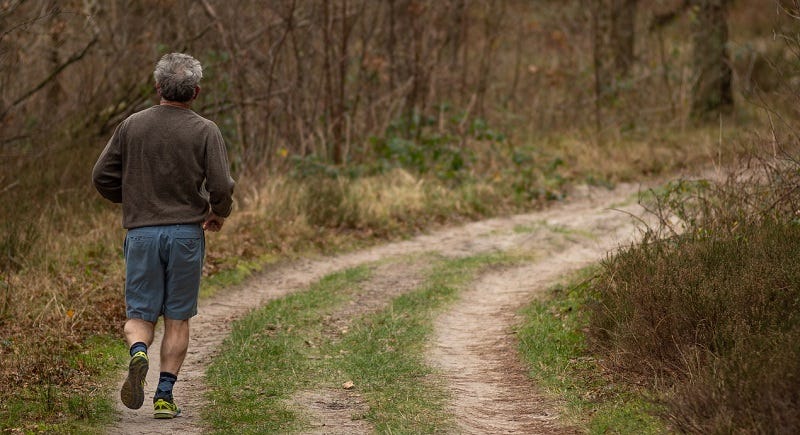 man jogging on a trail