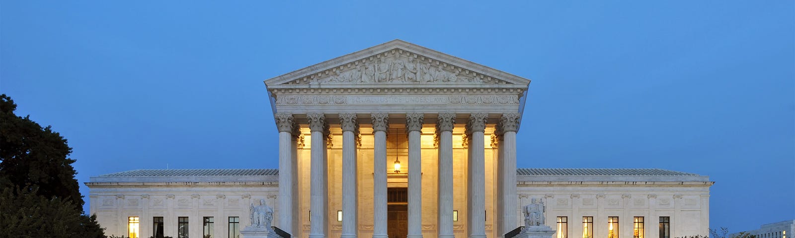 A panoramic photograph of the west facade of the Supreme Court of the United States building in Washington, DC, at dusk